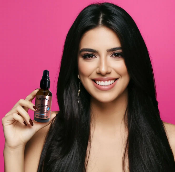 Latina beauty with healthy hair using Latinoil Chia Oil Hair Treatment Smiling Latina woman with long, shiny black hair holding Latinoil Chia Oil Hair Treatment against a pink background.